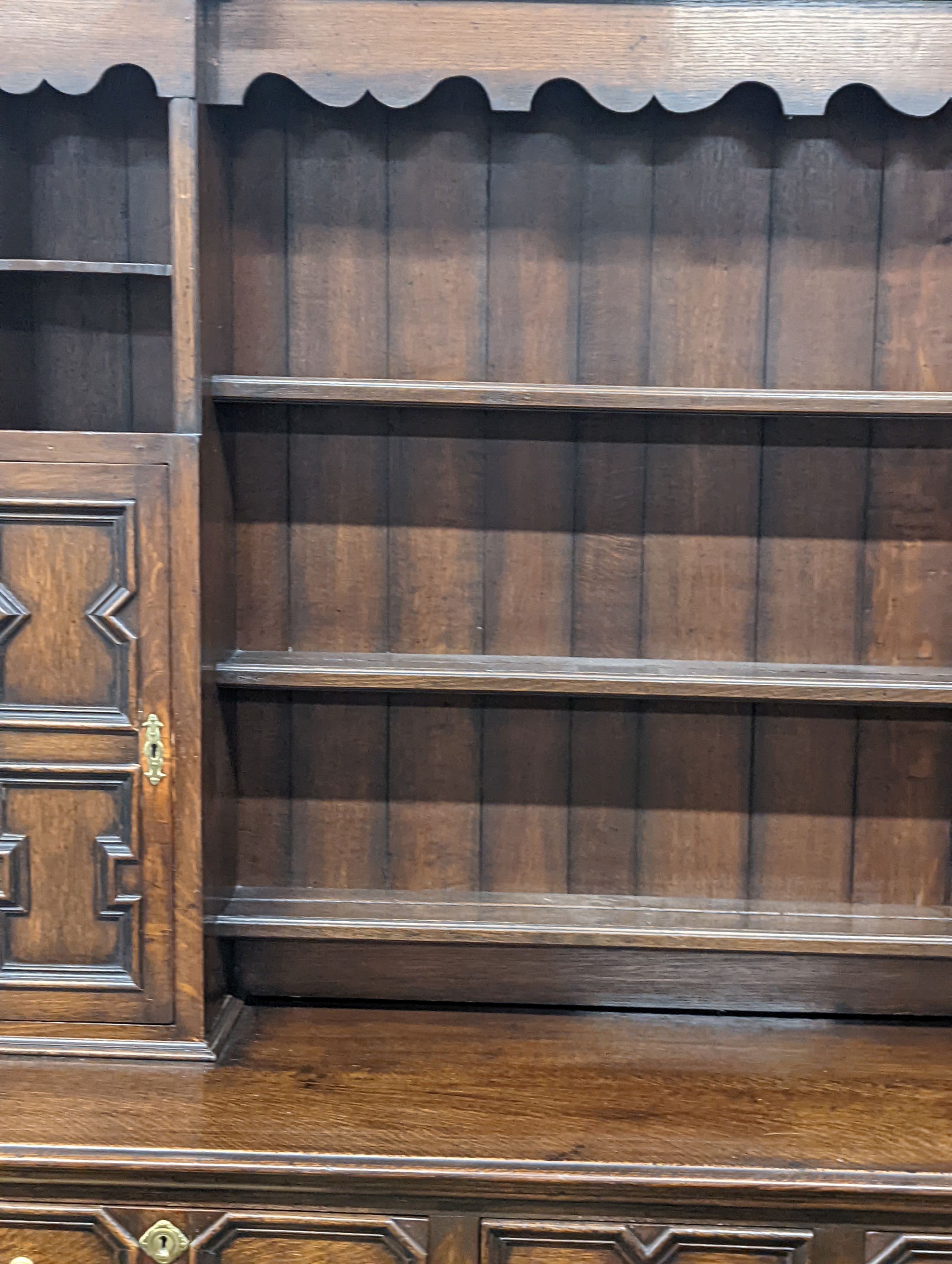 An early 20th century Jacobean revival oak dresser, width 168cm, depth 48cm, height 218cm